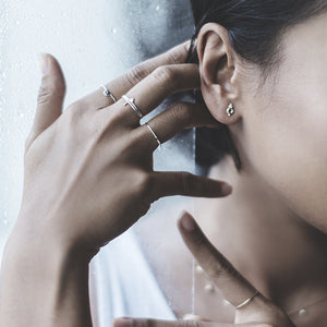 Gold and silver minimalist earrings and stacking rings. Fine jewellery.